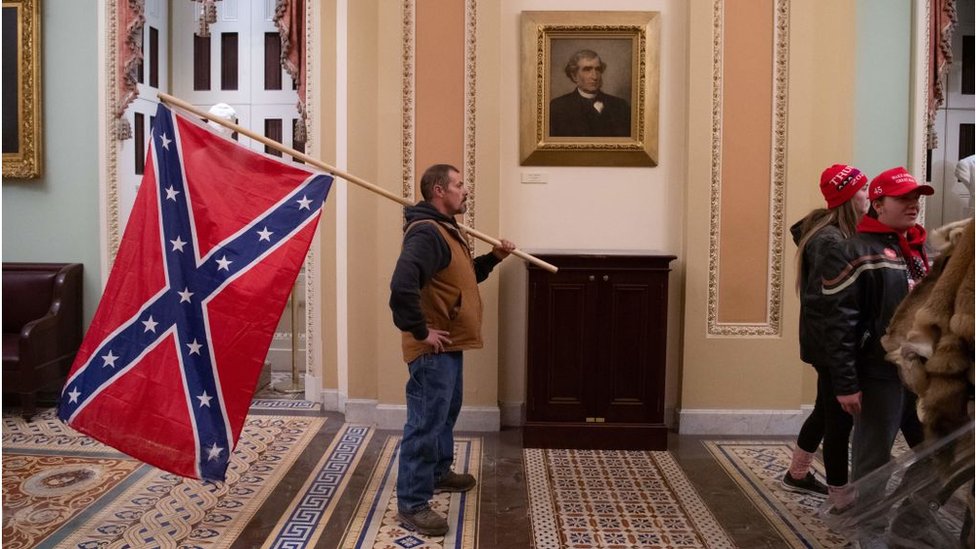 Man seen carrying a Confederate flag in the US Capitol