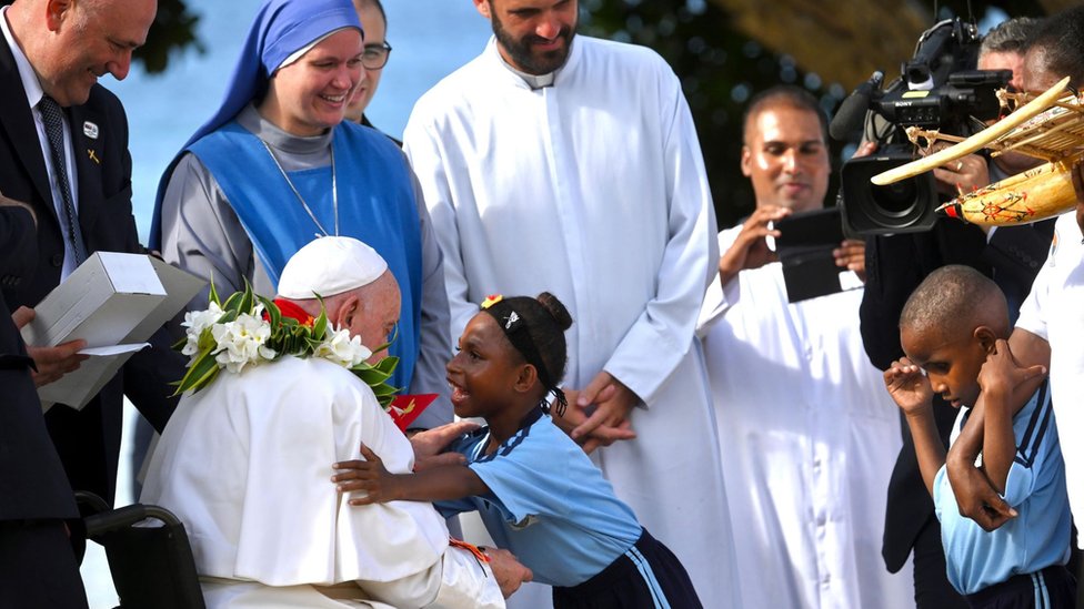 Pope Francis (2L) is welcomed by children at the Holy Trinity Humanistic School where the pontiff met with a group of missionaries at the school in Baro, Papua New Guinea, 08 September 2024.