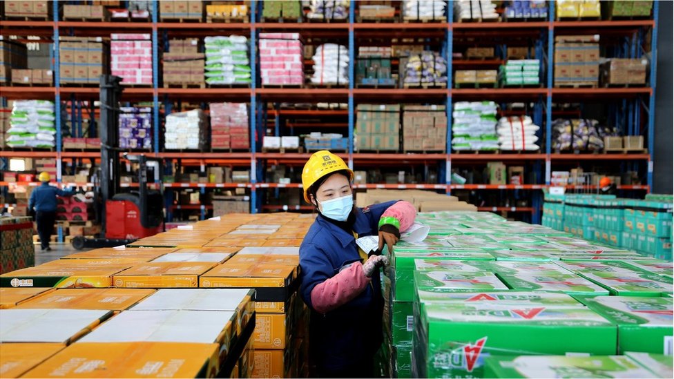 Employees arrange goods for the upcoming 'Double Eleven' online shopping festival at an e-commerce warehouse on December 8, 2020 in Lianyungang, Jiangsu Province of China.