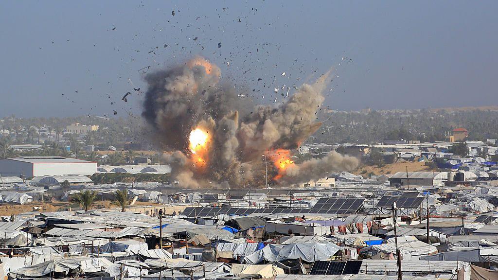Israeli air strikes kill at least 32 Palestinians in Gaza, rescue officials say