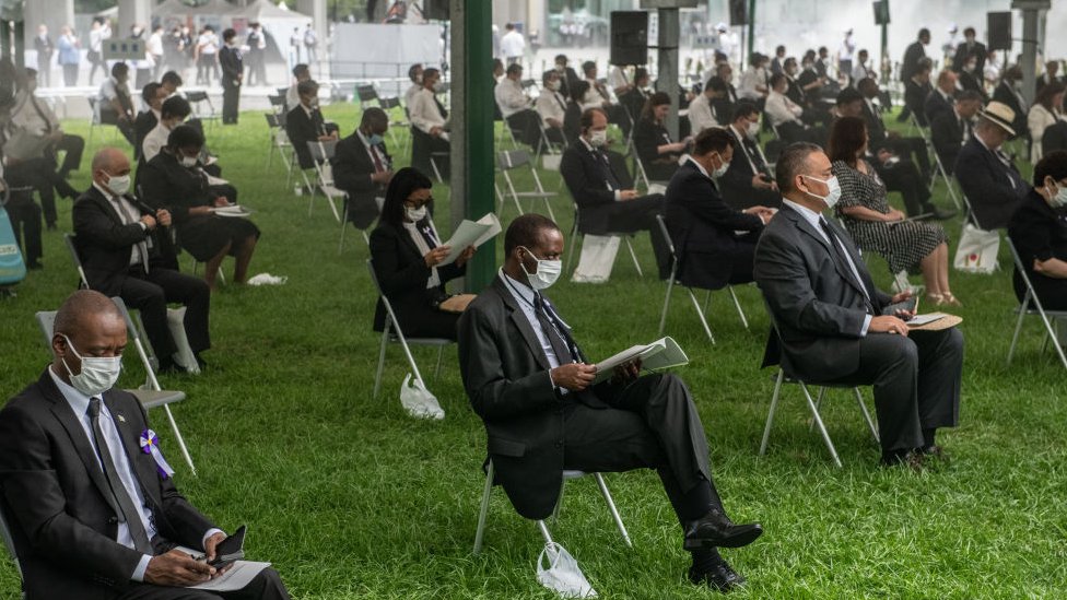 People sit in socially distanced chairs as a precaution against coronavirus as they as they attend the 75th anniversary of the Hiroshima atomic bombing,