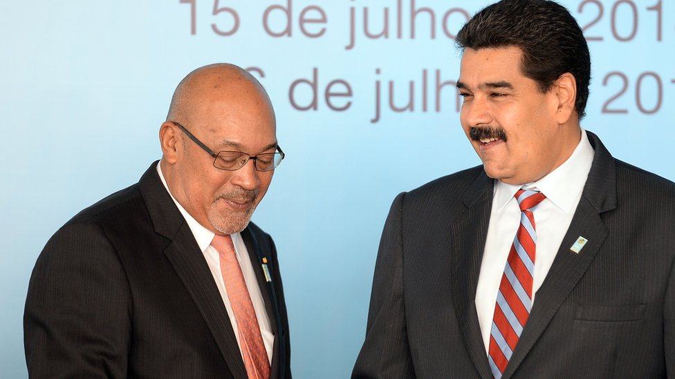Suriname`s President Desire Bouterse (L) and Venezuela`s President Nicolas Maduro shake hands before the family photo of the BRICS-UNASUR Summit in Brasilia on July 16, 2014.