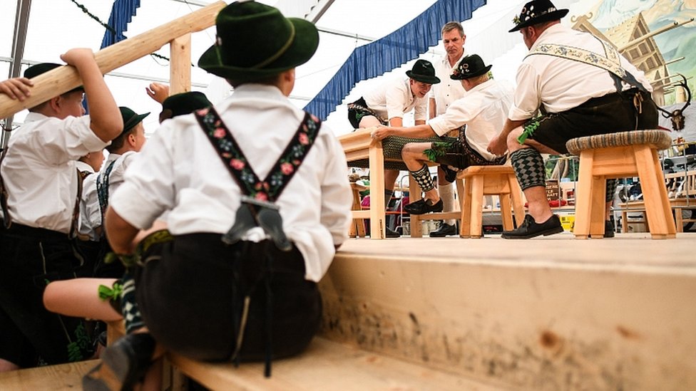 Children watch competitors face off in the German Finger Wrestling (Fingerhakeln) Championships in Garmisch-Partenkirchen, southern Germany, 15 August 2019