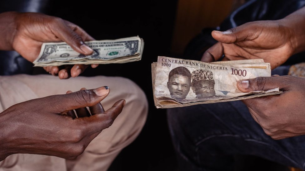 A customer exchanges Nigerian 1000 Naira banknotes for US dollar banknotes with a street currency dealer at a market in Lagos, Nigeria, on Monday, Sept. 25, 2023.
