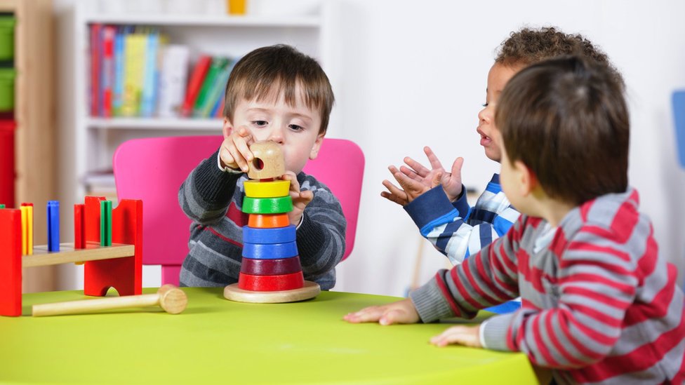 A group of boys playing with educational toys; stock photo