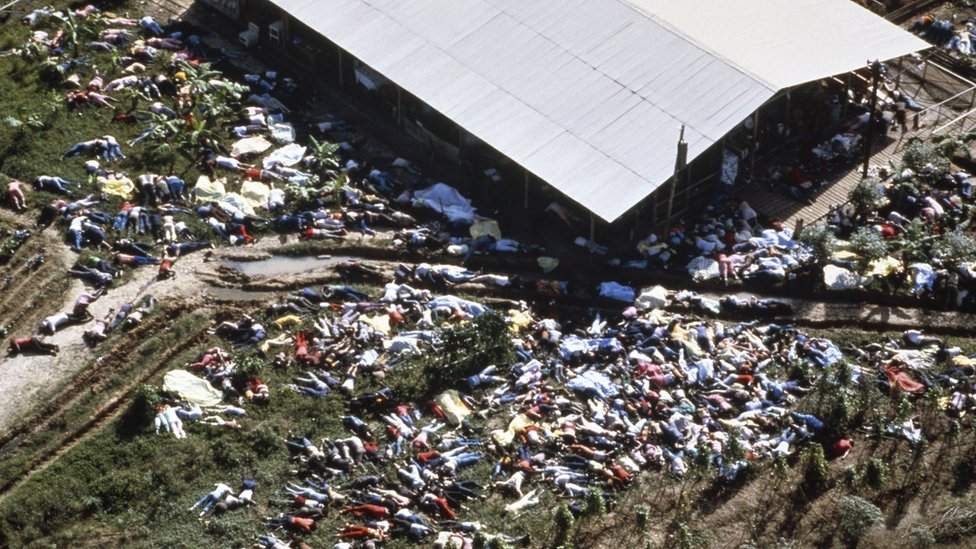 Hundreds of figures are photographed strewn round the building in aerial shot of Jonestown site