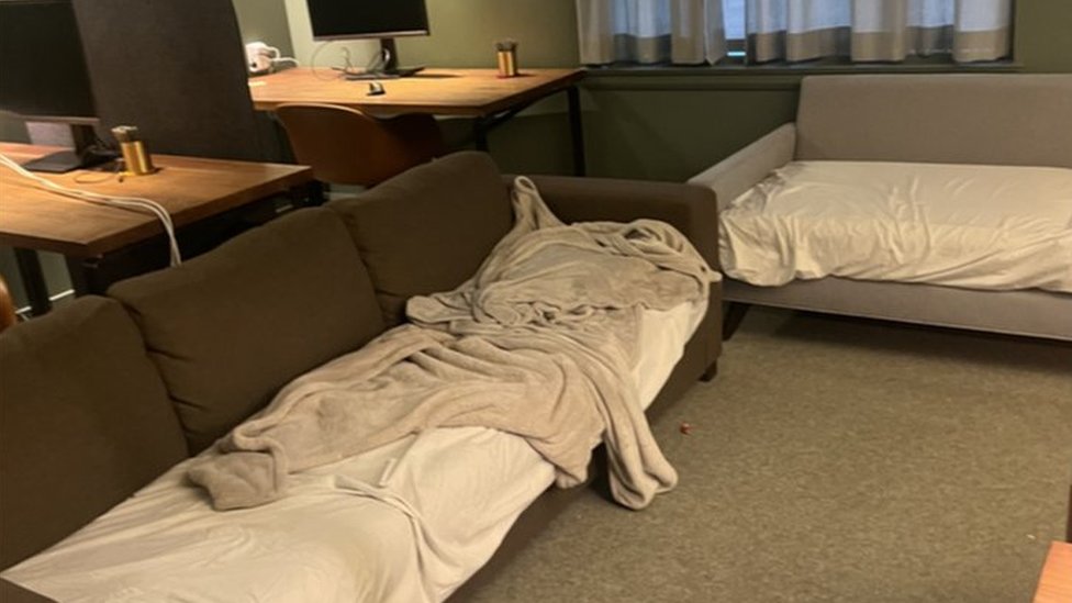 Dois sofás com lençóis no escritório