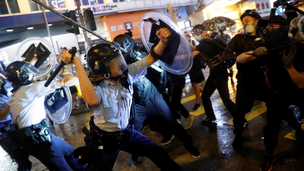 Police clash with anti-extradition bill protesters after a protest