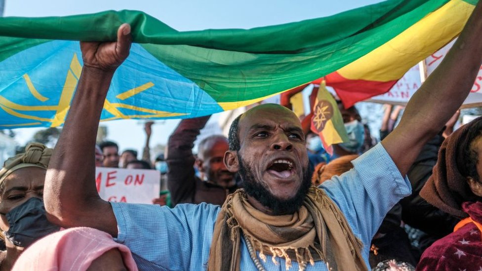 A demonstrator holds an Ethiopian flag as he takes part in a rally in Addis Ababa, Ethiopia, on November 7, 2021