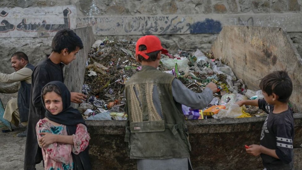Children looking in rubbish bins near Kabul airport - September 2021