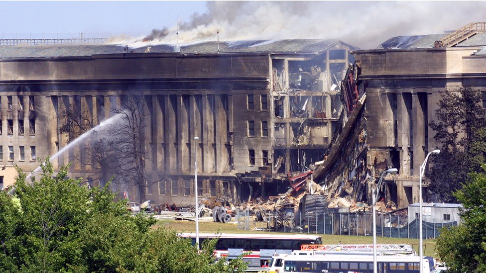 Smoke pours from the Southwest E-ring of the Pentagon building September 11, 2001 in Arlington, Virginia after a hijacked plane crashed into the building and set off a huge explosion.