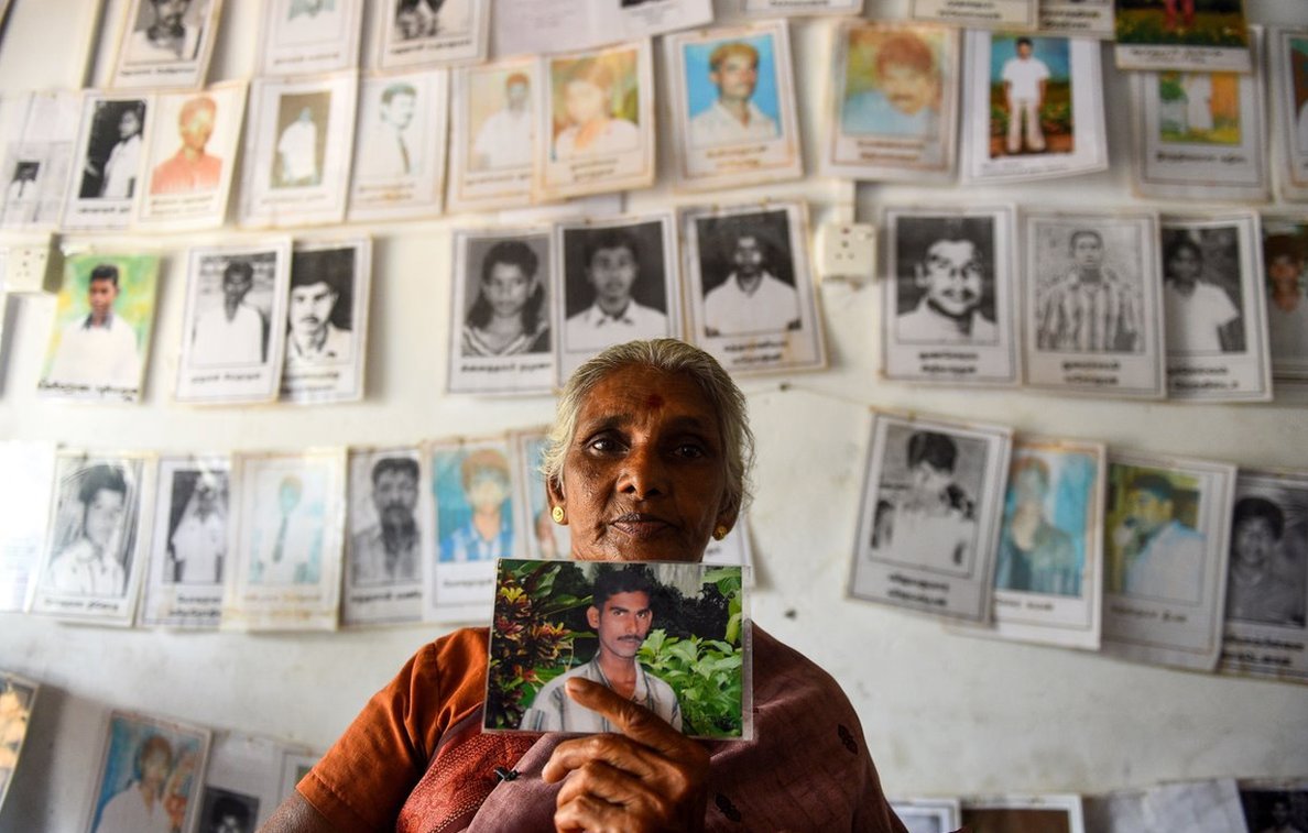 A Sri Lankan Tamil woman holds a picture of a missing loved one at the Missing people organization office in the district of Mullaittivu on May 17, 2019, ahead of the 10th anniversary of Sri Lankan troops defeating Tamil Tiger rebels and declaring an end to a 37-year-old separatist war that claimed at least 100,000 lives. - Sri Lanka marks on May 18 and 19 a decade since the end of its 37-year Tamil separatist war that claimed at least 100,000 lives. (Photo by ISHARA S. KODIKARA / AFP) (Photo credit should read ISHARA S. KODIKARA/AFP via Getty Images)