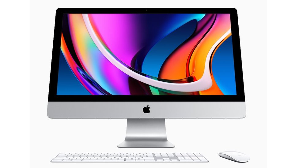 A new iMac is seen in this promotional image. The screen has a multicoloured flowing liquid displayed on it, while a wireless mouse and keyboard sit in front