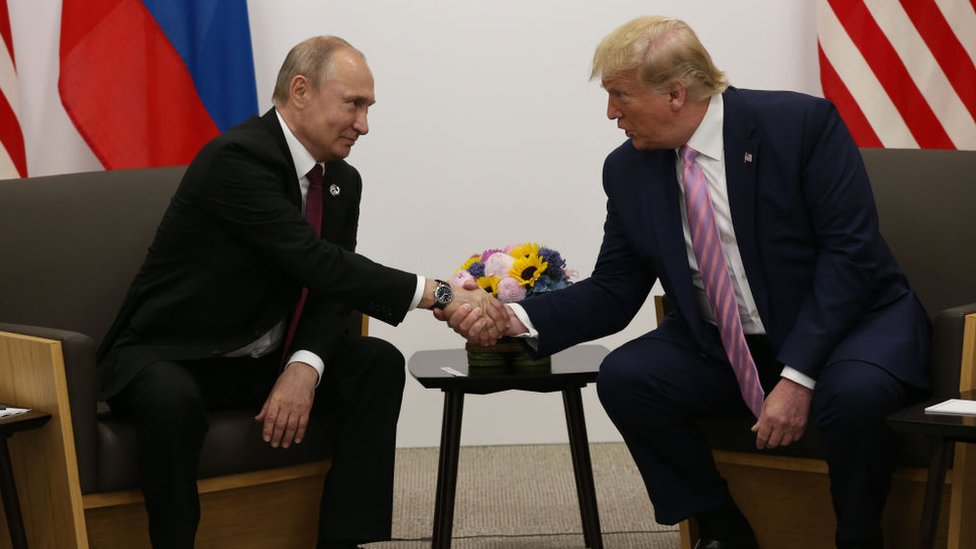 Putin shaking hands with US President Donald Trump