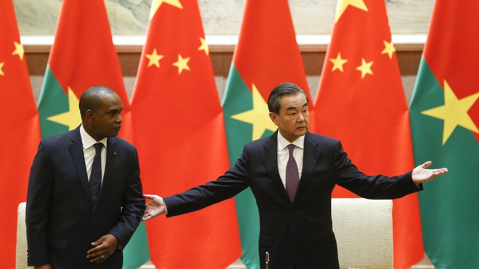 China's Foreign Minister Wang Yi (R) gestures beside Burkina Faso's Foreign Minister Alpha Barry as they attend a signing ceremony establishing diplomatic relations between the two countries in Beijing on May 26, 2018.