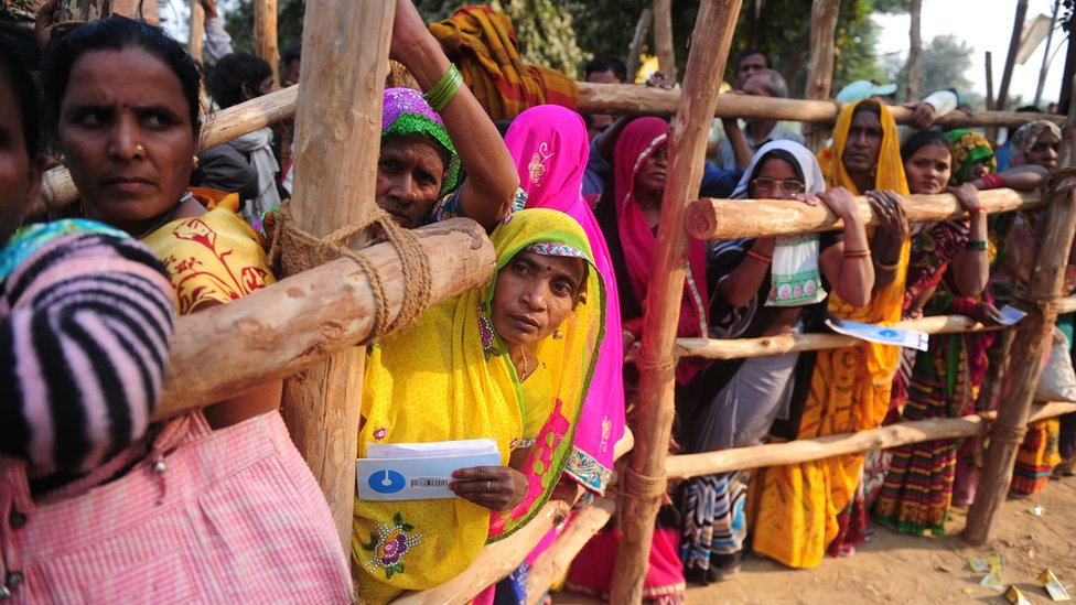 Жители индийских деревень выстраиваются в очередь перед банком, ожидая депонирования и обмена банкнот номиналом 500 и 1000 рупий в деревне Хануман Гандж на окраине Аллахабада 18 ноября 2016 г.