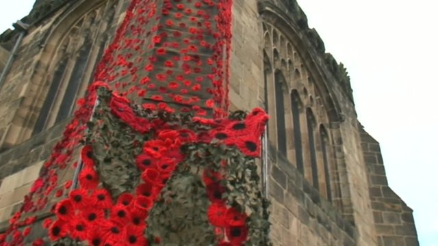 Knitted poppies display on the side of St Mary's Church, Thirsk