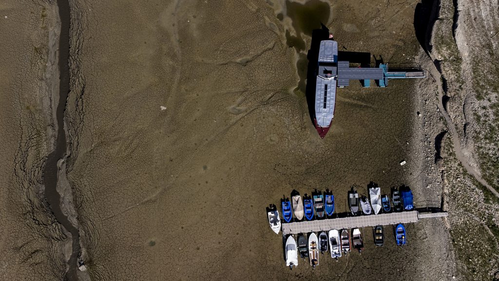 Drought leaves boats stranded on dried-up river bed along French-Swiss border