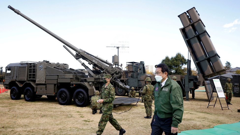 FILE PHOTO: Japan"s Prime Minister Fumio Kishida walks past a Japan Ground Self-Defense Force (JGSDF) Type 19 155 mm wheeled self-propelled howitzer and a Type 12 surface-to-ship missile as he inspects equipment during a review at Japan Ground Self-Defense Force (JGSDF) Camp Asaka in Tokyo, Japan, November 27, 2021.