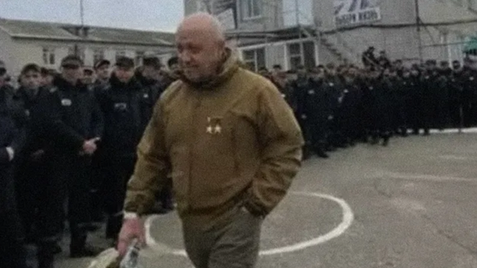 Wagner leader Yevgeny Prigozhin walks past a line of prisoners in a leaked video