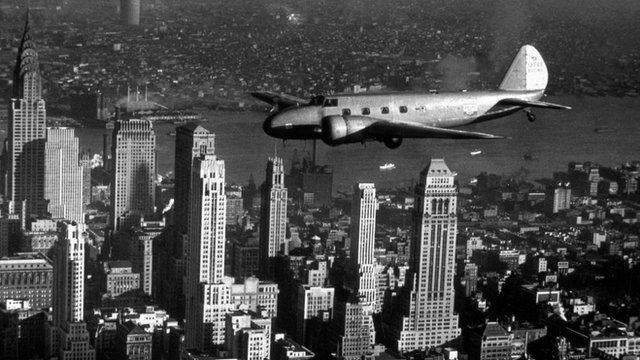 A Boeing Model 247D flies over New York