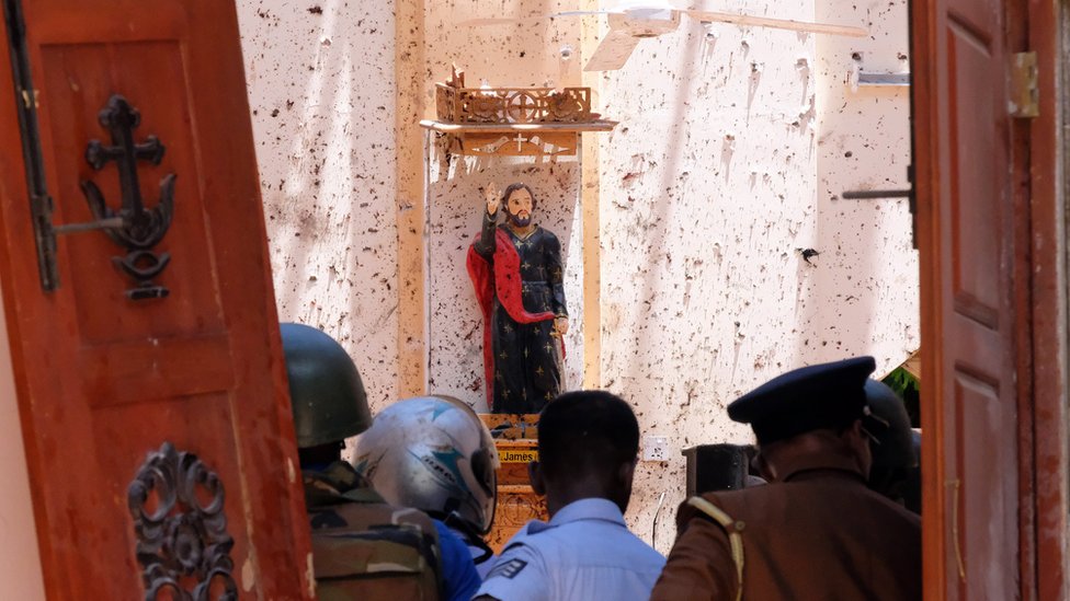 A statue of St. James is pictured after a bomb blast inside a church in Negombo