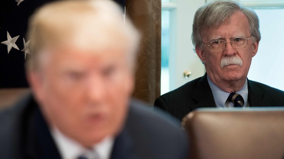 John Bolton looks at Donald Trump