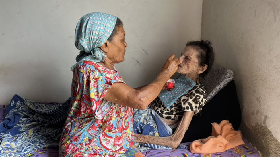 Josefa Maria da Conceicao being fed by her 76-year-old-daughter Cicera