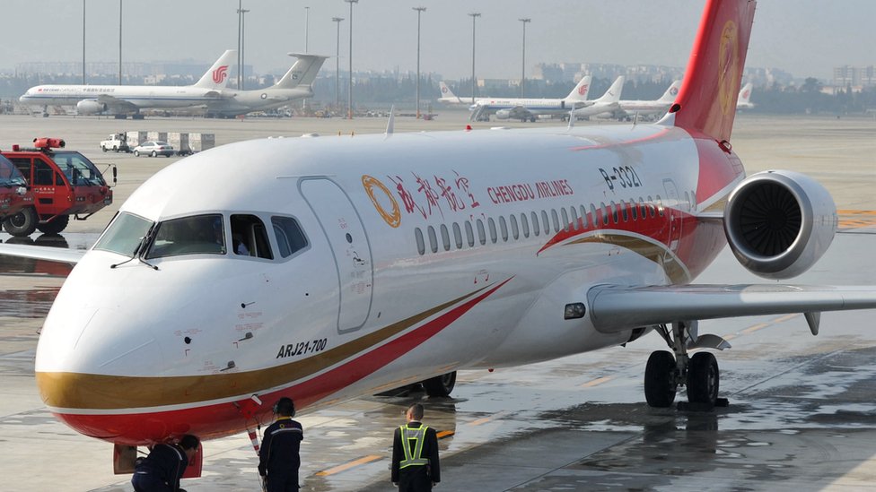 Члены экипажа Chengdu Airlines празднуют прибытие самолета ARJ21 в международный аэропорт Шуанлю 29 ноября 2015 года
