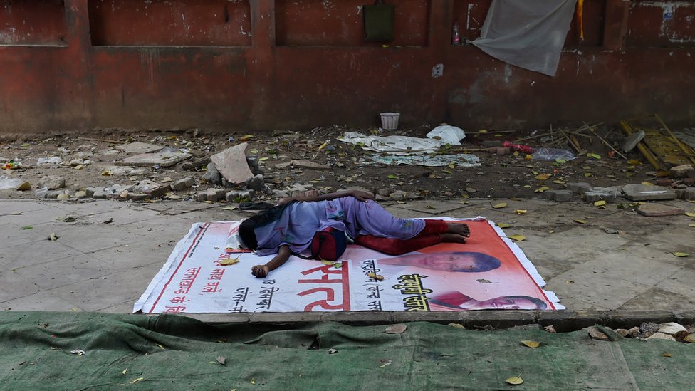 Бездомная индианка спит на обочине пешеходной дорожки в Нью-Дели 18 августа 2015 г.