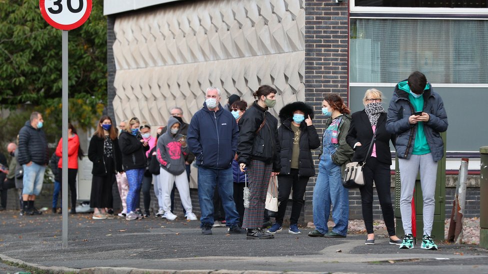 People queuing outside a walk-in coronavirus test centre at Allerton Library in Liverpool amid rising cases across parts of England