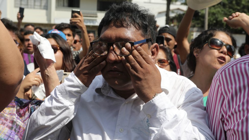 Supporters of the Peruvian ex-president Alan Garcia gather outside the Casimiro Ulloa Emergency Hospital in Lima. 17 April 2019