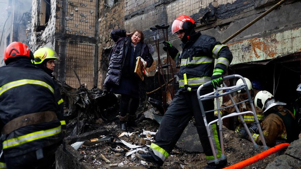 Firefighters work to rescue a local resident from a site of a residential building heavily damaged during a Russian missile attack, amid Russia's attack on Ukraine, in Kyiv, Ukraine January 2