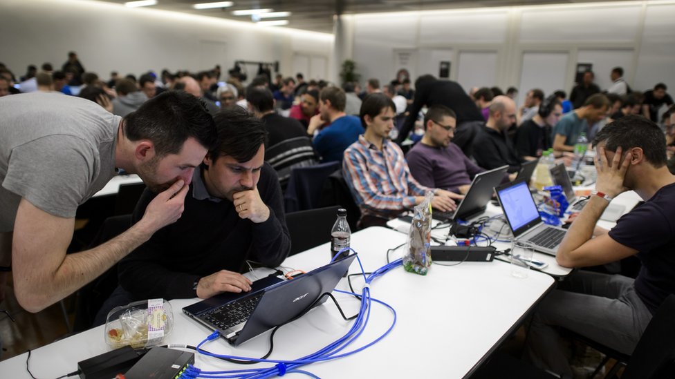 Participants compete behind their computers during the ethical hacking contest Insomni'hack 2014 on March 21, 2014 in Geneva