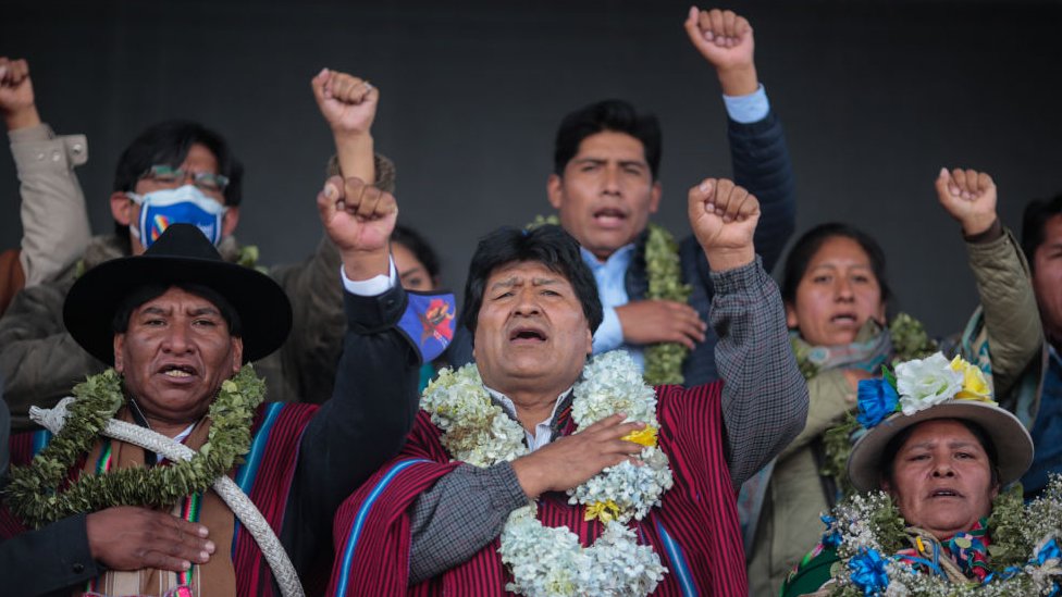Evo Morales canta puño en alto con otros militantes.