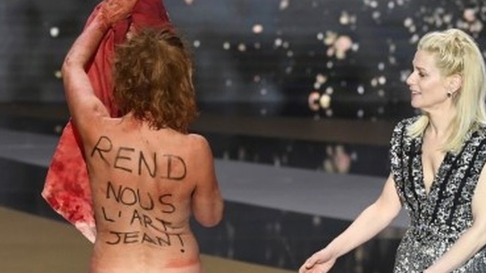 Corinne Masiero strips naked during a protest at the Cesar Awards