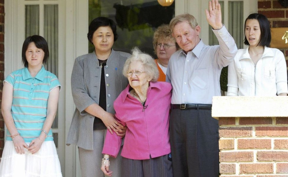 65-летний Чарльз Дженкинс позирует для фотографий со своей матерью Патти Каспер, своей женой Хитоми Сога и их дочерьми Бриндой и Микой после воссоединения с 91-летней матерью в Велдоне, Северная Каролина