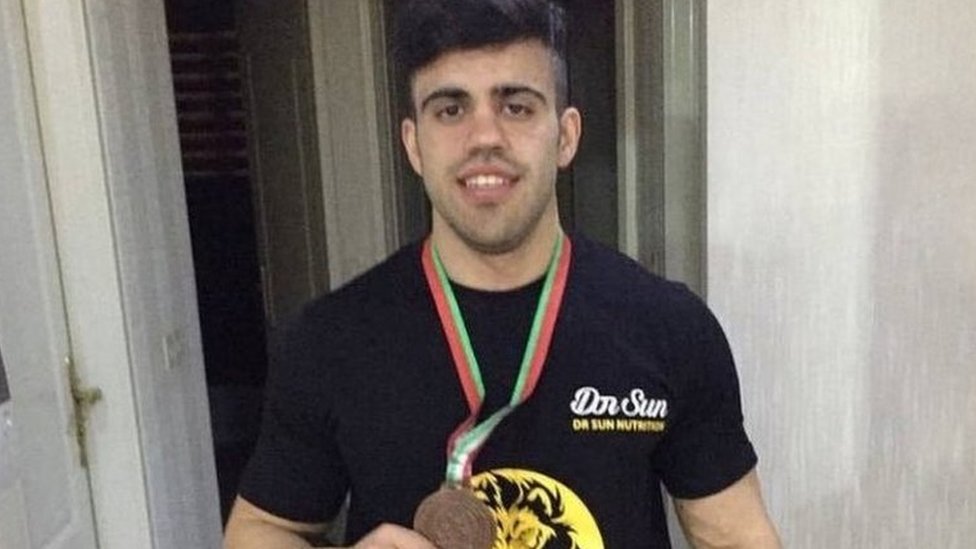 Sahand Noormohammadzadeh holds a medal he won for bodybuilding