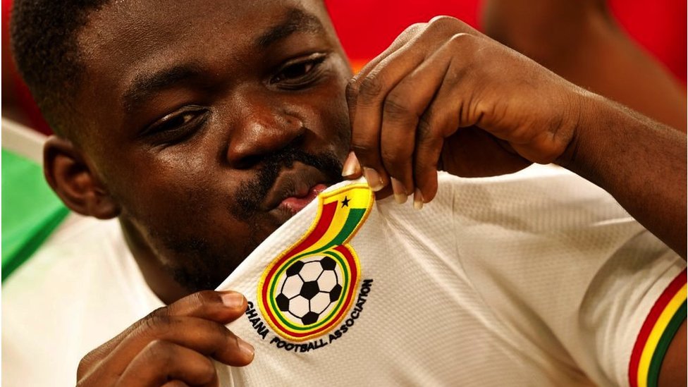 A Ghana fan kisses his shirt during the game against Portugal in the 2022 Fifa Men's World Cup