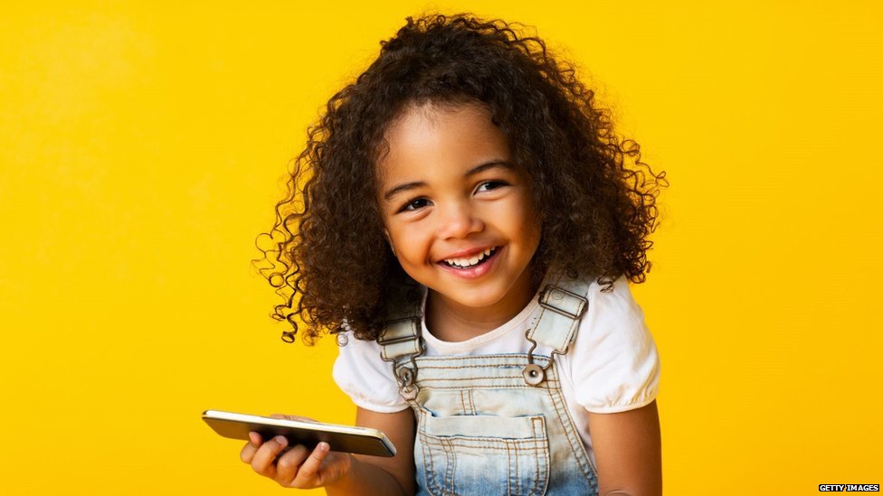 Young black girl holidng a mobile phone