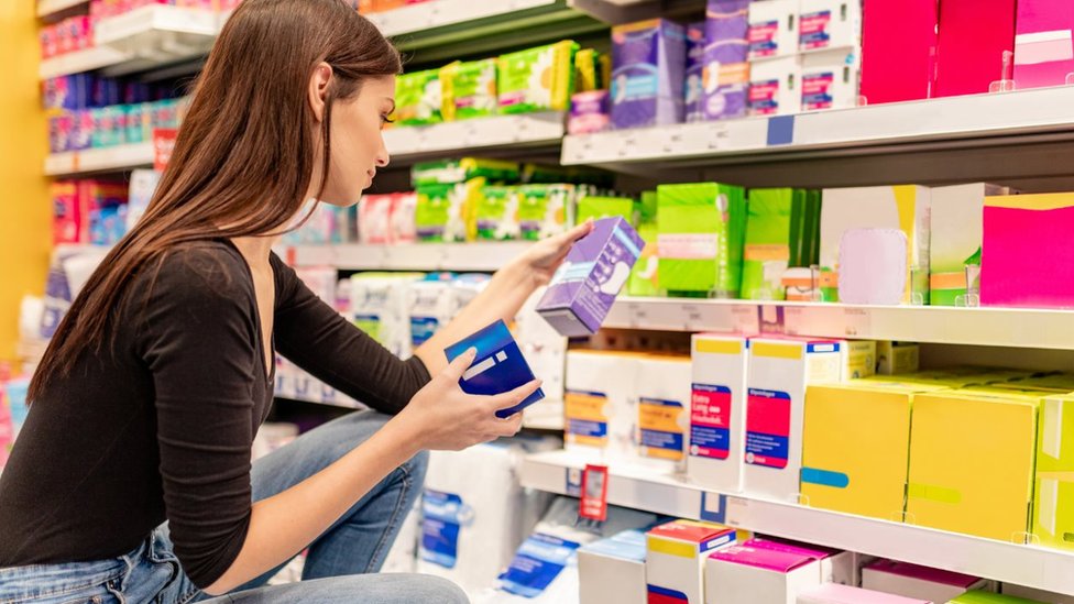 Young woman shopping for sanitary products