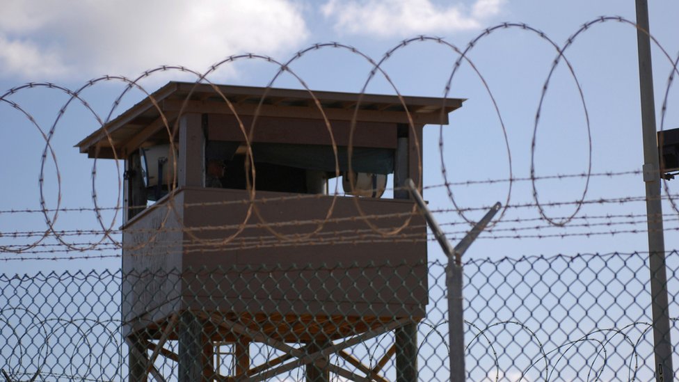 A soldier stands guard in a tower overlooking Camp Delta at Guantanamo Bay naval base in a 31 December 2009 file photo provided by the US Navy.