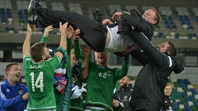 Northern Ireland players lift manager Michael O'Neill