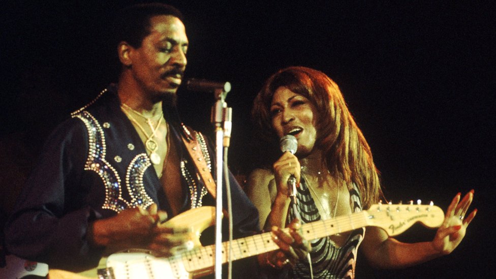 Tina Turner and Ike Turner (1931-2007) on left playing Fender Stratocaster guitar, of the Ike & Tina Turner Revue perform live on stage at the Hammersmith Odeon in London on 24th October 1975
