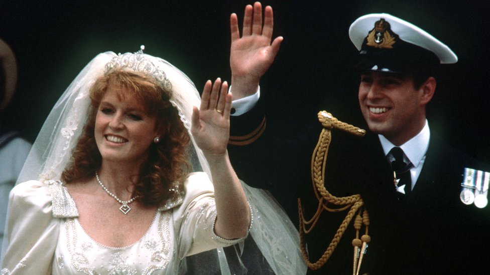 Prince Andrew and his bride Sarah Ferguson wave to crowds as they leave Westminster Abbey, London after their wedding ceremony for Buckingham Palace reception