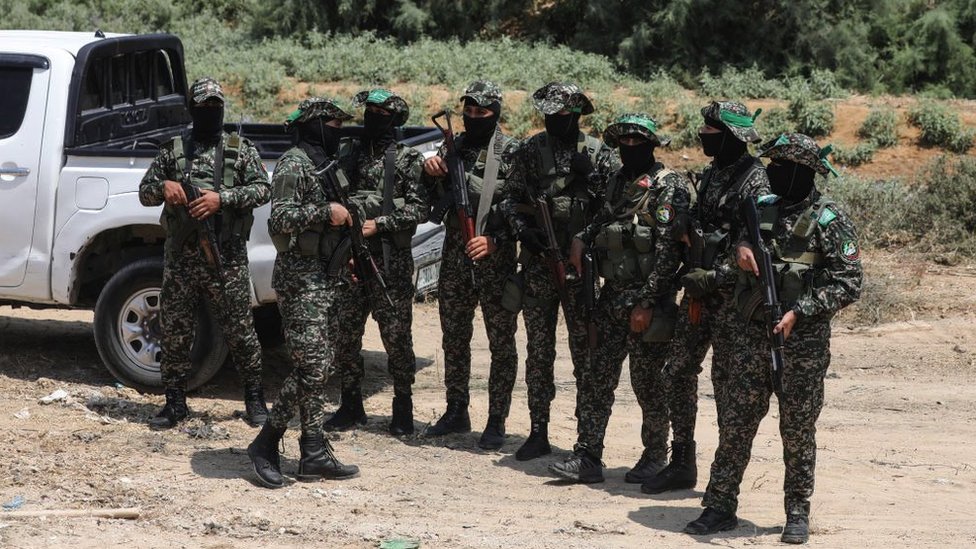 Masked members of the al-Qassam Brigades, the military wing of Hamas at al-Bureij refugee camp in the central Gaza strip, on 8 August 2022