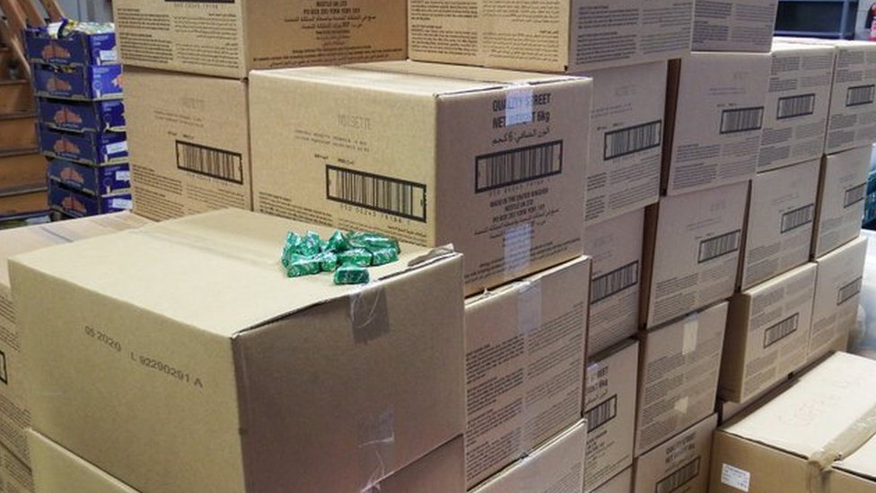 Несколько картонных коробок с разбросанными сверху конфетами