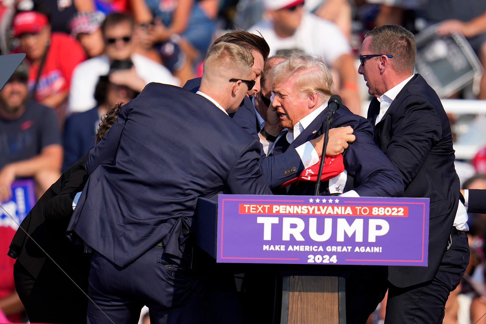 Agents lift Trump and tend to his wounded ear