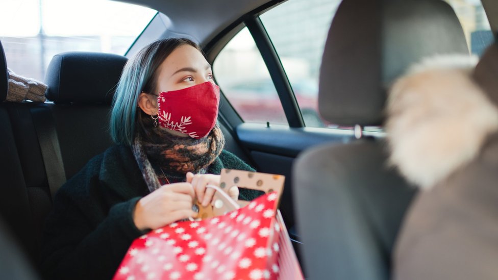 Woman in mask in car