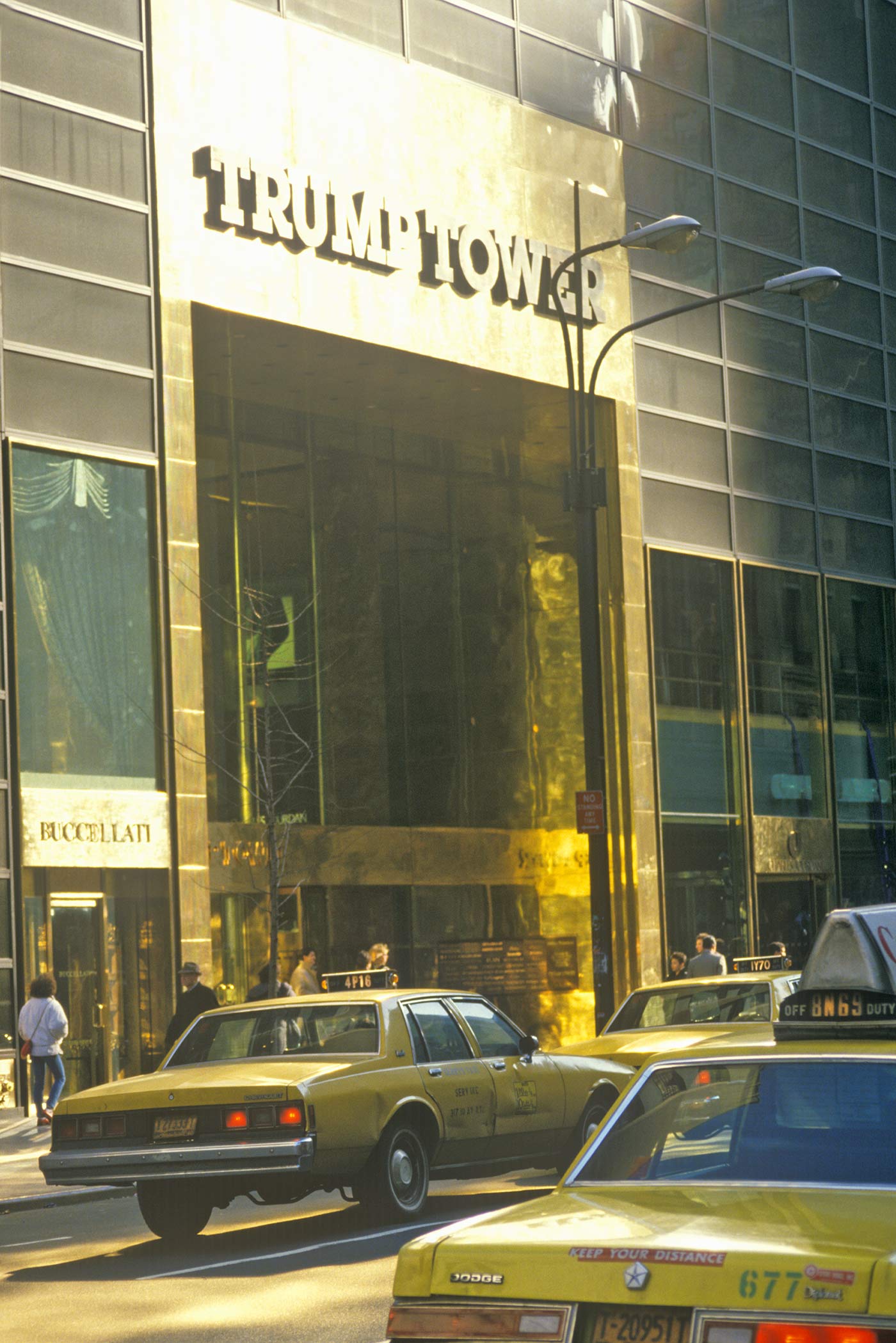 Taxis drive past the side entrance to Trump Tower in 1985